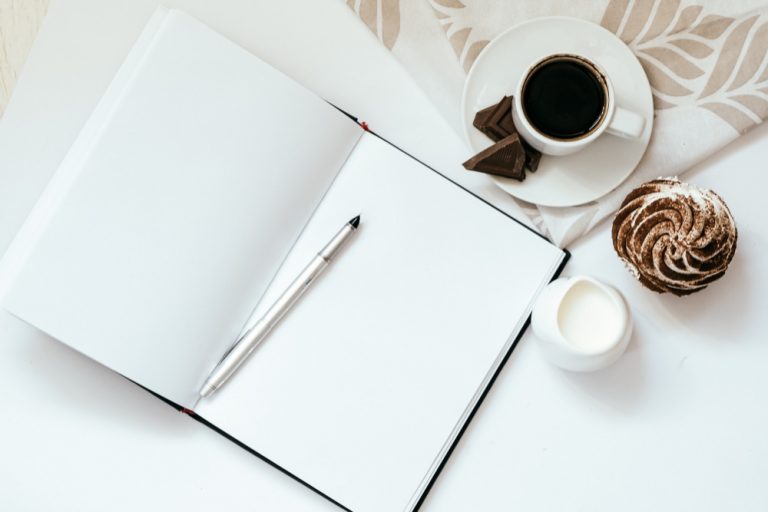 Open notebook and mug on a sunlit desk as a neutral illustration of planning daily rhythms in Australia